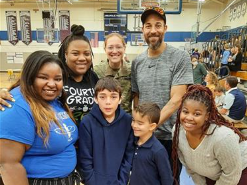 Three teacehrs from Meade Heighs Elementary pose with 4th grade students at regional competition